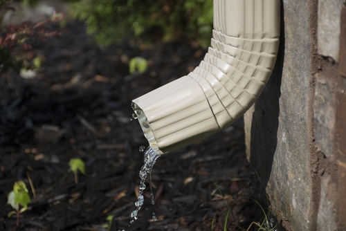 rain gutter downspout with water